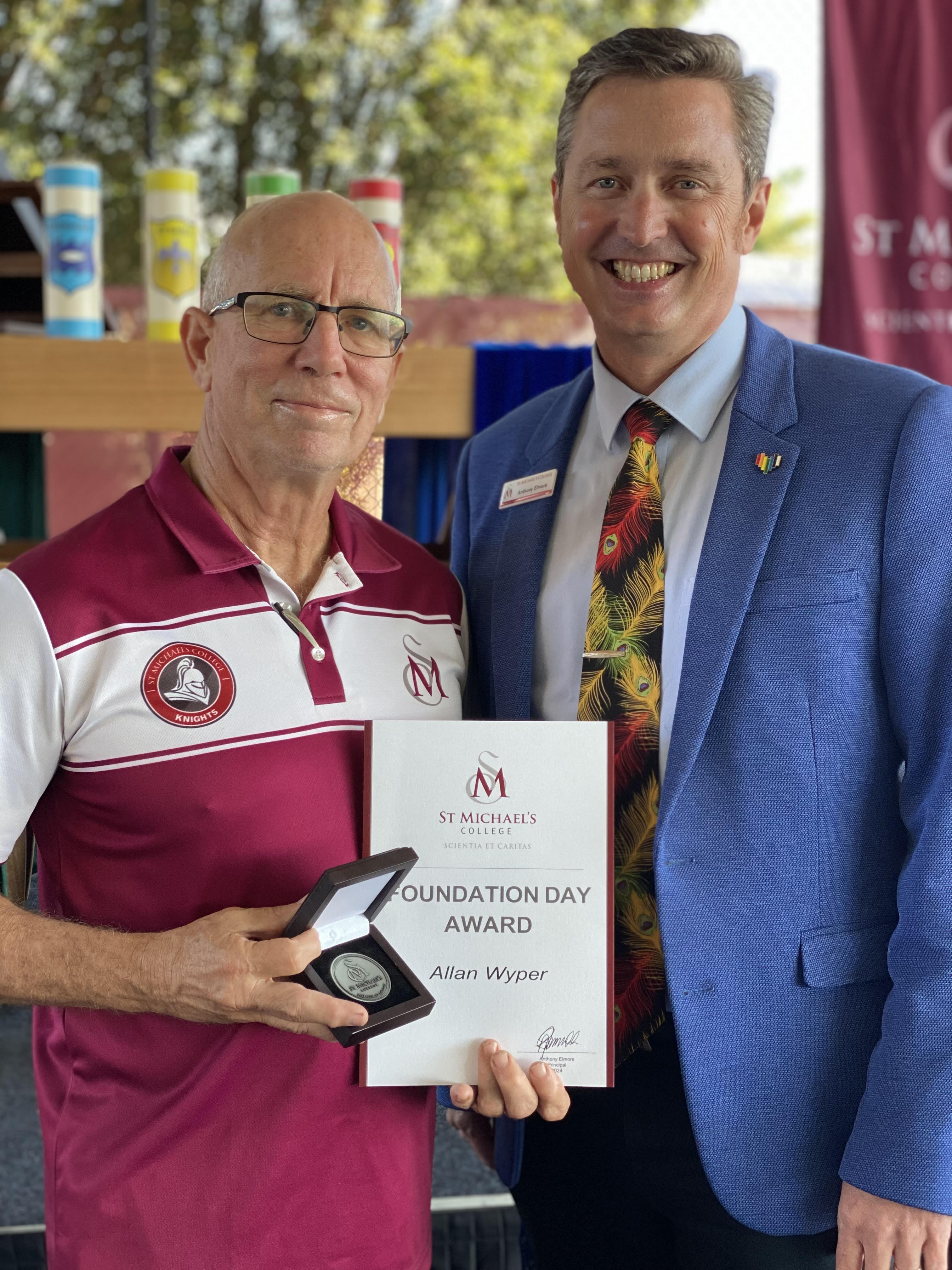 Staff member Allan, presenting Foundation Day award at school event