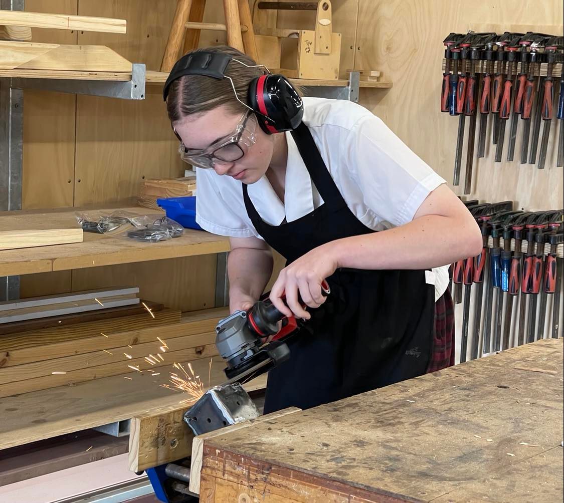 Student using a grinder at the workshop