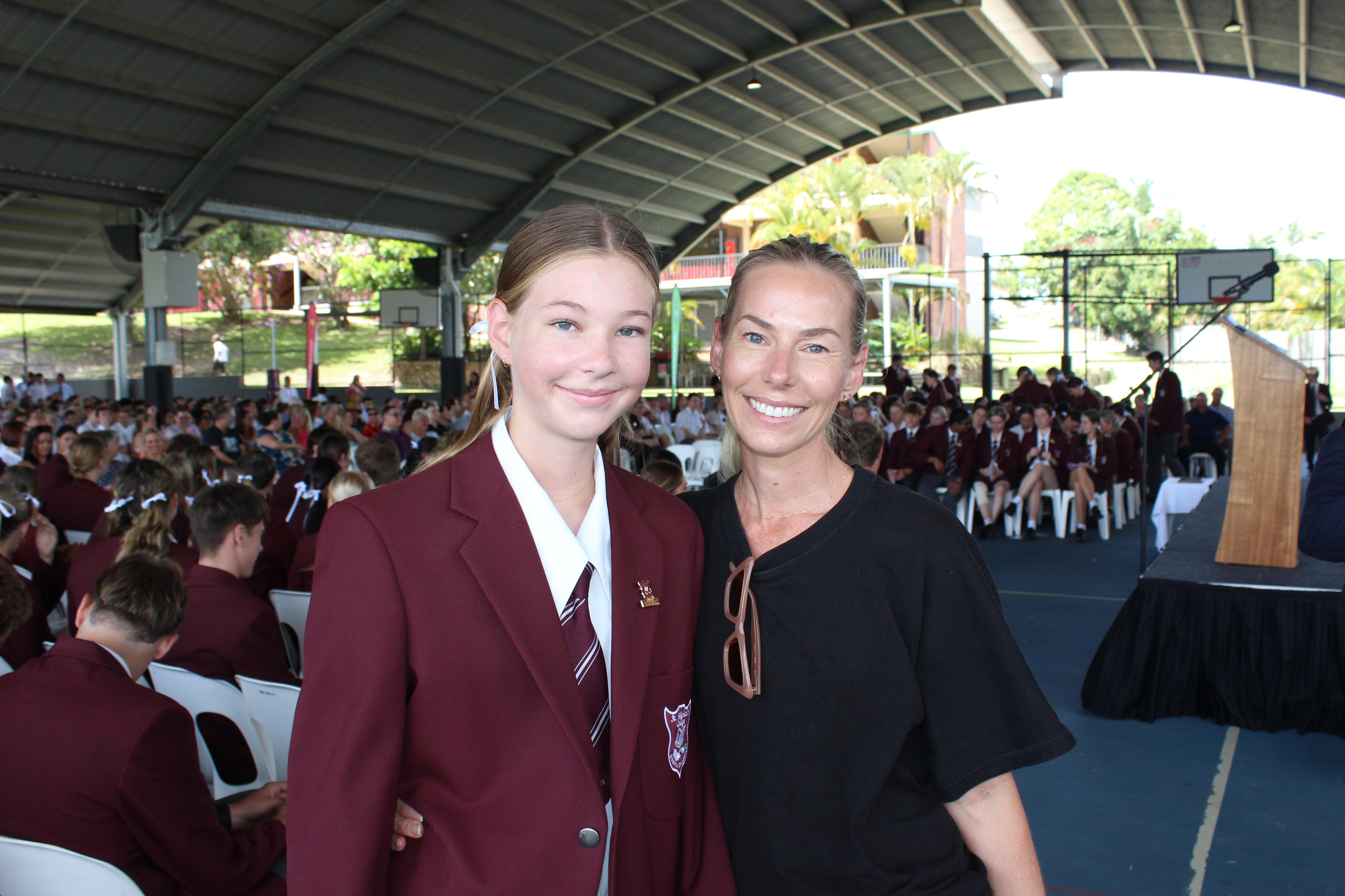 Student with family member at 2024 commencement Mass ceremony