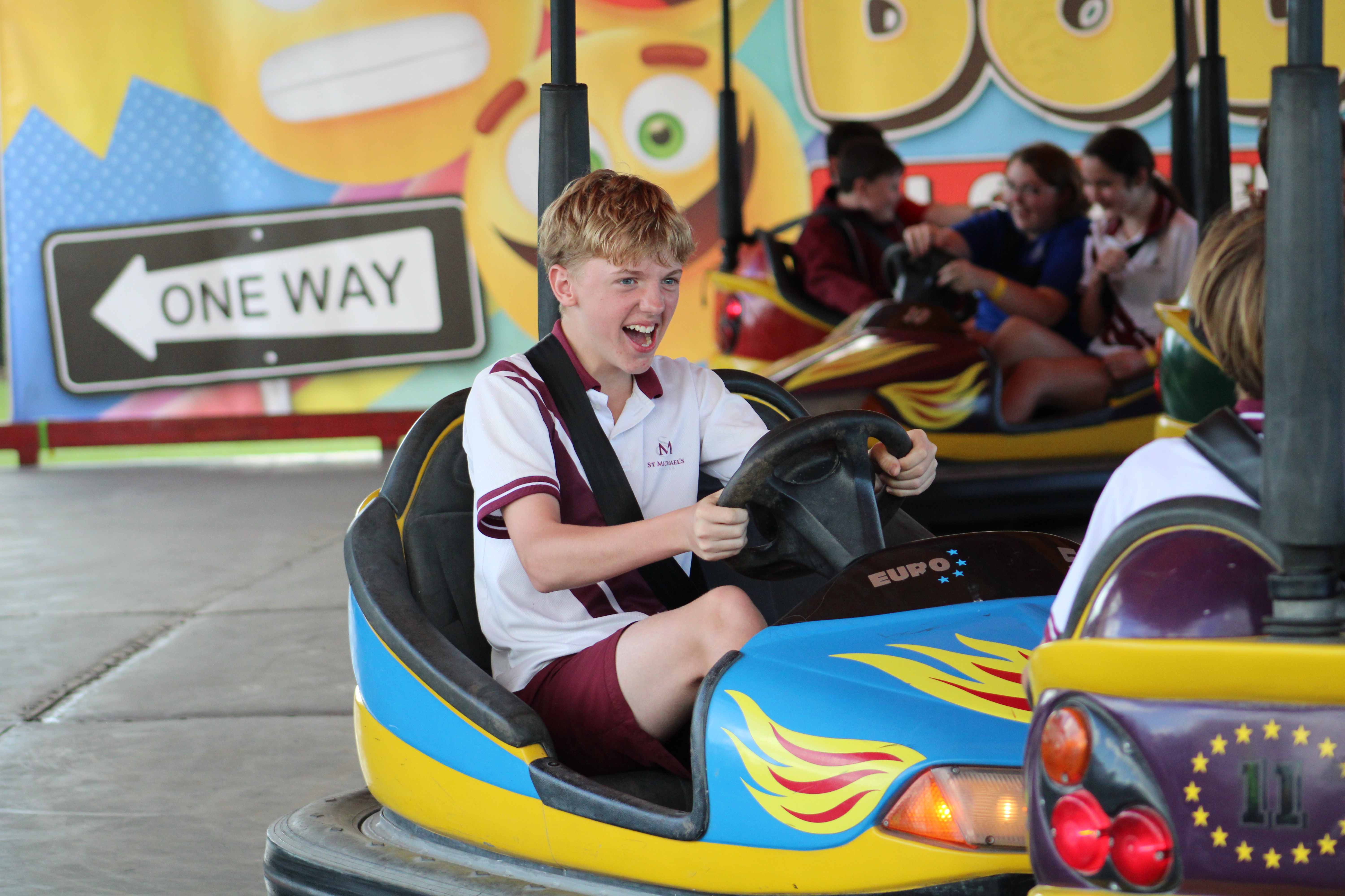 Student driving bumper car during school activity