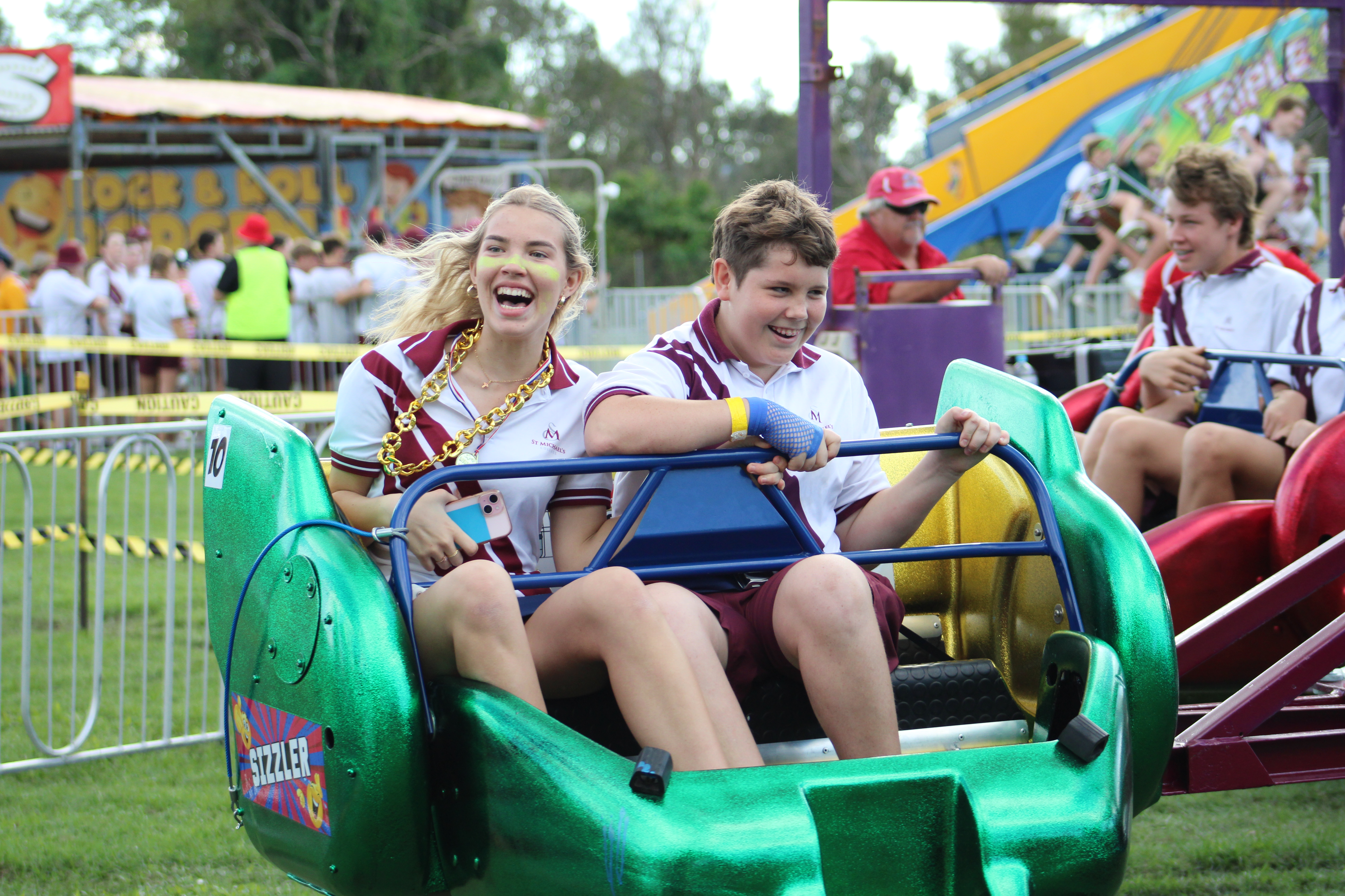 Students riding amusement ride during school carnival
