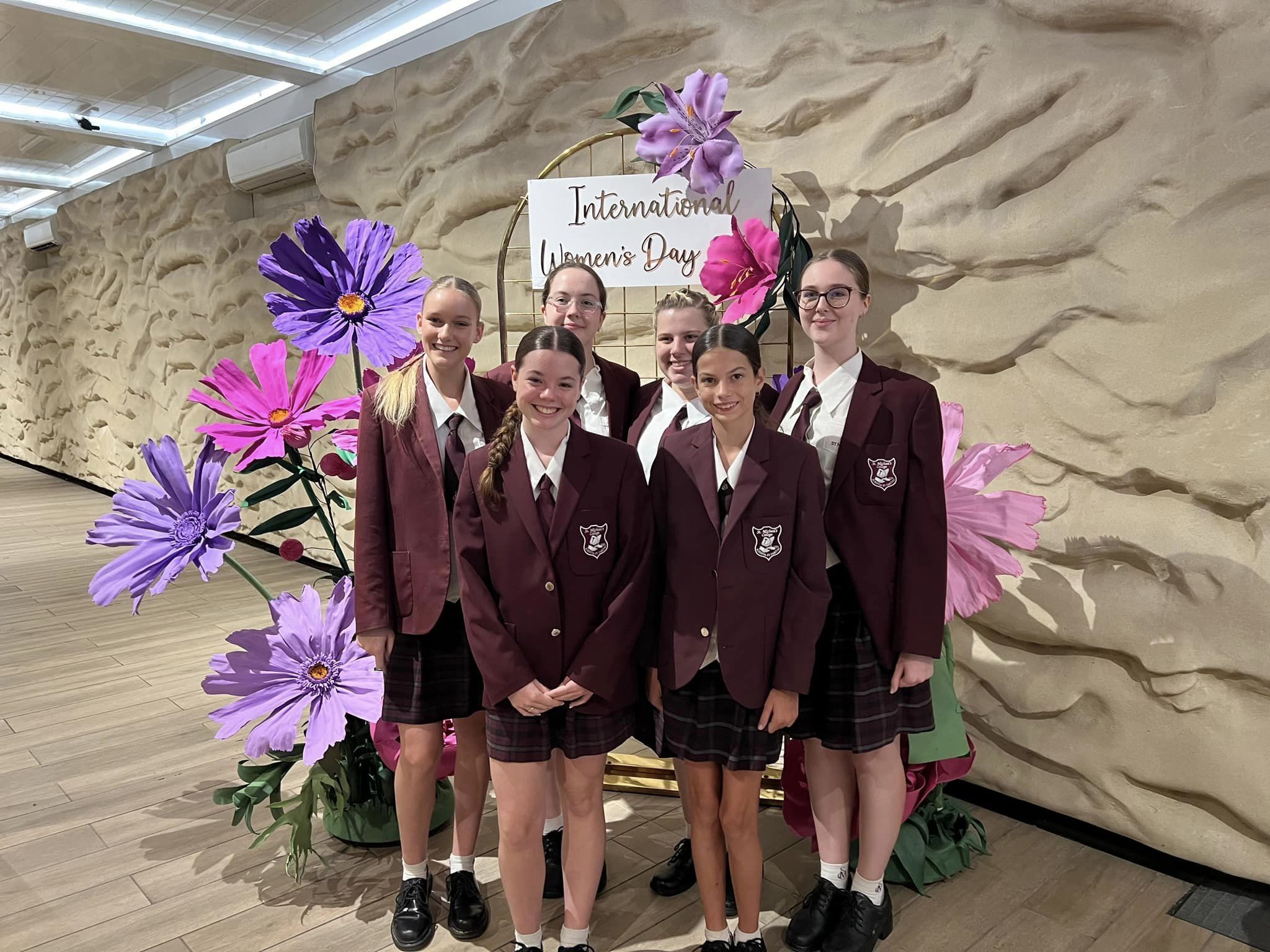 Students standing at International Women’s Day school display